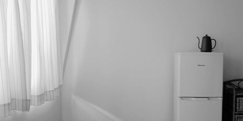 部屋とカーテンと冷蔵庫とチェスト